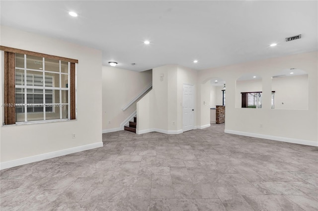 13227 SW 42nd St Unit 8103, Miramar, FL 33027 - unfurnished living room featuring arched walkways, stairs, and recessed lighting