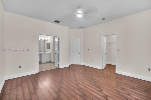 13227 SW 42nd St Unit 8103, Miramar, FL 33027 - unfurnished bedroom featuring dark wood finished floors, a walk in closet, ensuite bath, and a closet