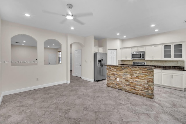 13227 SW 42nd St Unit 8103, Miramar, FL 33027 - kitchen with appliances with stainless steel finishes, ceiling fan, arched walkways, white cabinets, and glass insert cabinets