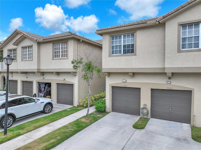 13227 SW 42nd St Unit 8103, Miramar, FL 33027 - multi unit property featuring a garage, stucco siding, driveway, and a tile roof