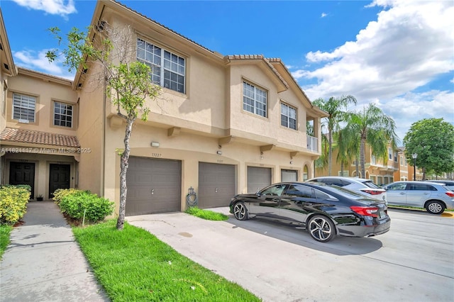 13227 SW 42nd St Unit 8103, Miramar, FL 33027 - multi unit property with stucco siding, an attached garage, driveway, and a tile roof