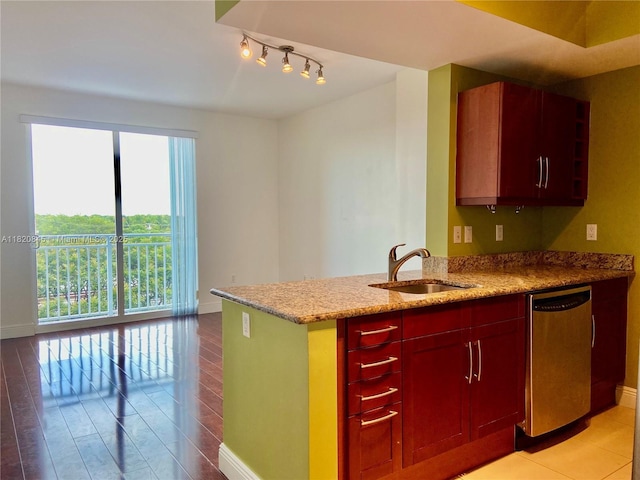 7275 SW 90th Way Unit 405, Miami, FL 33156 - kitchen featuring stainless steel dishwasher, light stone countertops, a peninsula, rail lighting, and light wood-style flooring