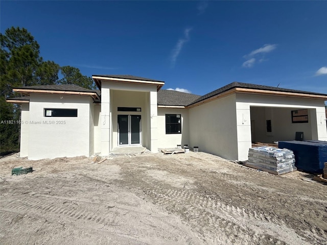 811 Rush Ave, Lehigh Acres, FL 33972 - prairie-style home with stucco siding and a garage