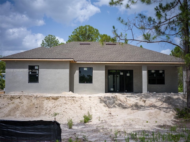 811 Rush Ave, Lehigh Acres, FL 33972 - back of property with stucco siding and a shingled roof