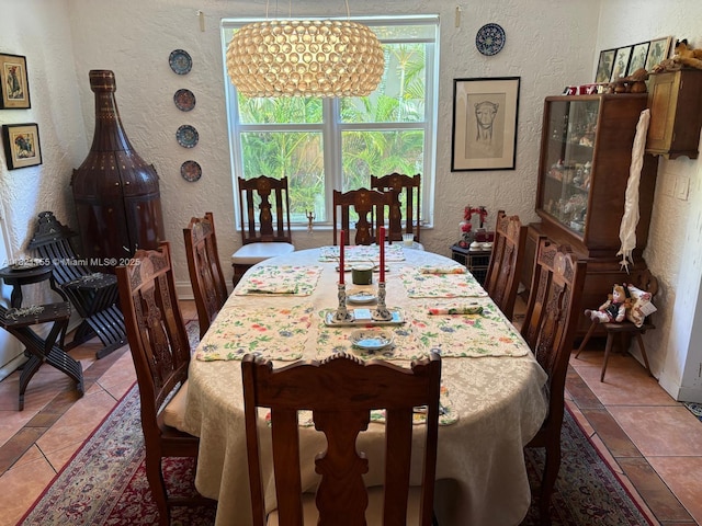 3767 Royal Palm Ave, Miami Beach, FL 33140 - dining room featuring a textured wall, healthy amount of natural light, and a chandelier