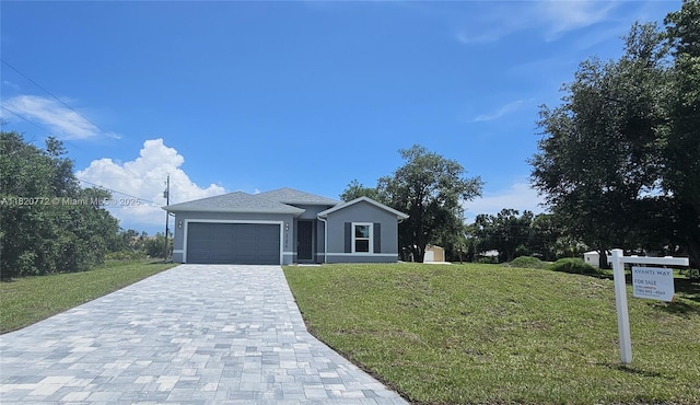 21475 Argosy Ave, Port Charlotte, FL 33954 - view of front of property featuring decorative driveway, a garage, a front lawn, and stucco siding