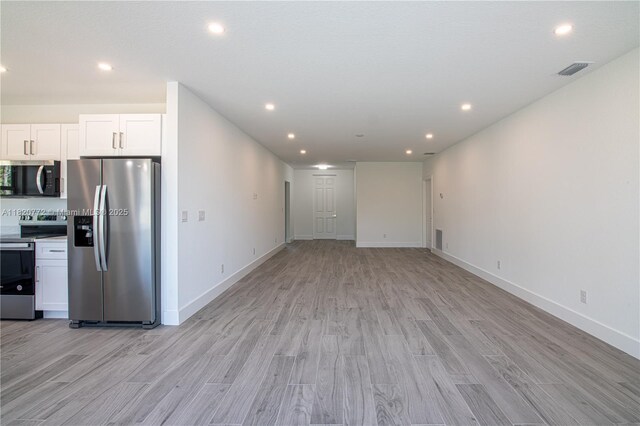 21475 Argosy Ave, Port Charlotte, FL 33954 - kitchen featuring stainless steel appliances, light wood finished floors, white cabinets, recessed lighting, and open floor plan