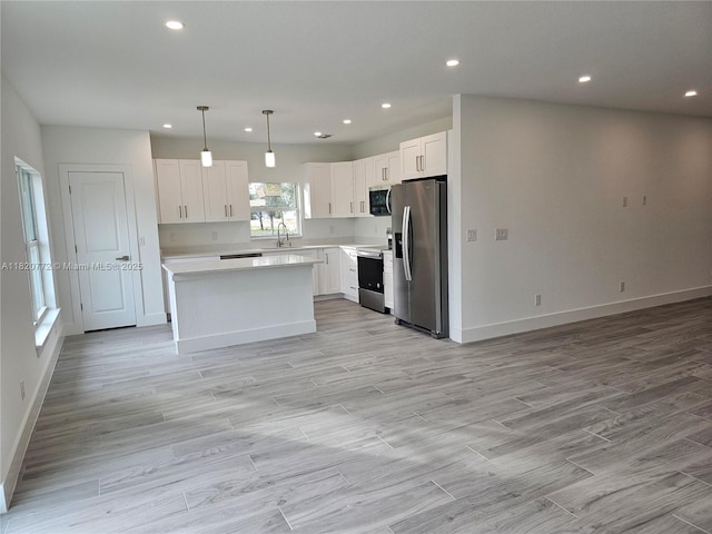 21475 Argosy Ave, Port Charlotte, FL 33954 - kitchen with appliances with stainless steel finishes, light countertops, open floor plan, white cabinets, and recessed lighting