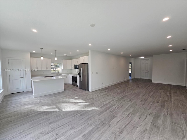 21475 Argosy Ave, Port Charlotte, FL 33954 - unfurnished living room with light wood-type flooring and recessed lighting