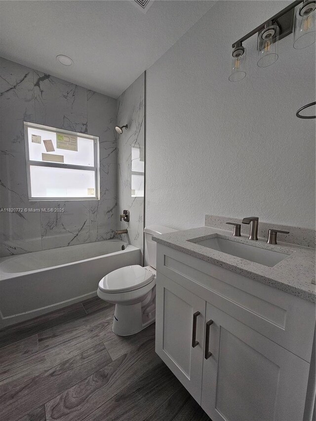 21475 Argosy Ave, Port Charlotte, FL 33954 - bathroom with bathtub / shower combination, vanity, wood finished floors, and a textured wall