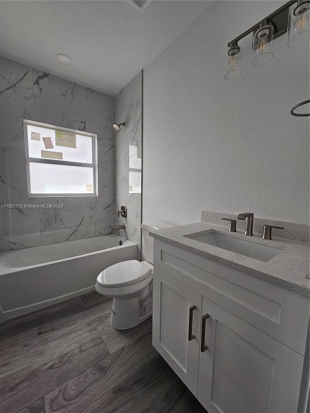 21475 Argosy Ave, Port Charlotte, FL 33954 - full bathroom with shower / tub combination, vanity, wood finished floors, and a textured wall