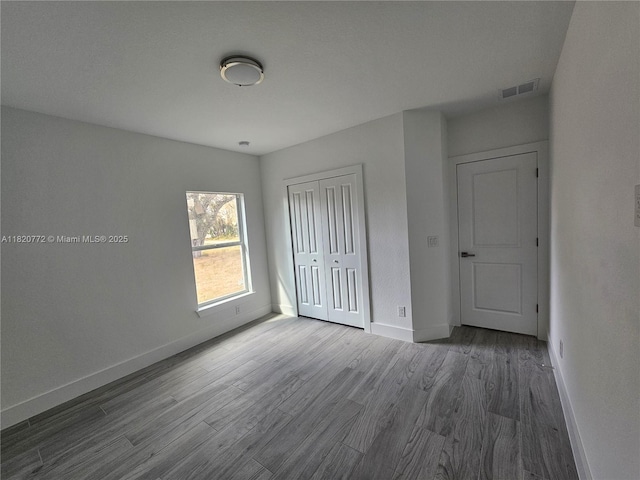 21475 Argosy Ave, Port Charlotte, FL 33954 - unfurnished bedroom featuring wood finished floors and a closet