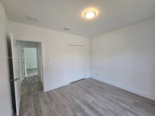 21475 Argosy Ave, Port Charlotte, FL 33954 - unfurnished bedroom with wood finished floors and a closet