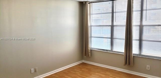 3800 S Ocean Dr Unit 425, Hollywood, FL 33019 - spare room featuring baseboards and wood finished floors