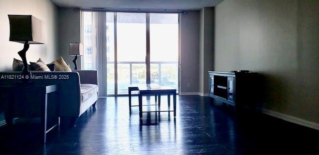 3800 S Ocean Dr Unit 425, Hollywood, FL 33019 - living area featuring floor to ceiling windows, healthy amount of natural light, and dark wood-style flooring