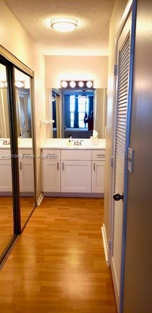 3800 S Ocean Dr Unit 425, Hollywood, FL 33019 - bathroom featuring wood finished floors, vanity, and a textured ceiling