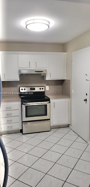 3800 S Ocean Dr Unit 425, Hollywood, FL 33019 - kitchen with stainless steel electric stove, under cabinet range hood, white cabinetry, and light tile patterned flooring