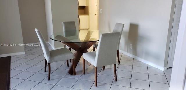 3800 S Ocean Dr Unit 425, Hollywood, FL 33019 - dining space featuring baseboards and light tile patterned floors