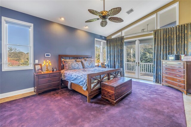 8755 Commodore Dr, Seminole, FL 33776 - carpeted bedroom featuring access to exterior, multiple windows, vaulted ceiling, recessed lighting, and ceiling fan