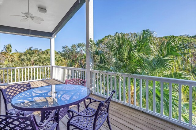 8755 Commodore Dr, Seminole, FL 33776 - wooden terrace featuring outdoor dining area and ceiling fan