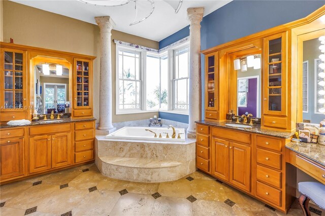 8755 Commodore Dr, Seminole, FL 33776 - bathroom featuring ornate columns, two vanities, and a bath