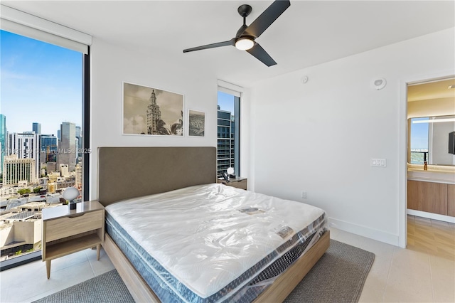 159 NE 6th St Unit 3016, Miami, FL 33132 - bedroom featuring multiple windows, light tile patterned floors, expansive windows, a skyline view, and a ceiling fan