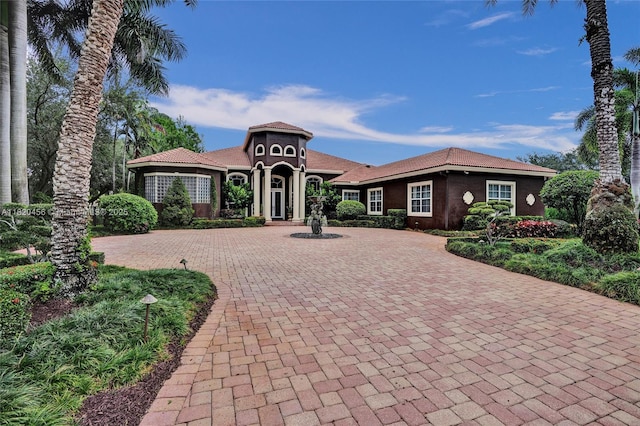 15093 SW 16th St, Davie, FL 33326 - mediterranean / spanish house with curved driveway and stucco siding