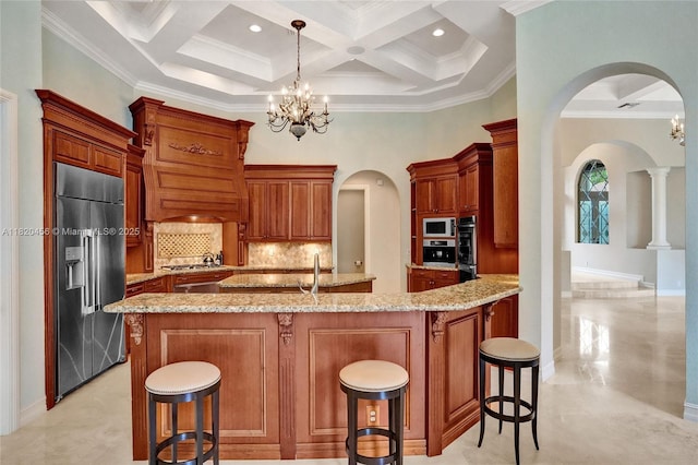 15093 SW 16th St, Davie, FL 33326 - kitchen featuring appliances with stainless steel finishes, arched walkways, a chandelier, backsplash, and beamed ceiling