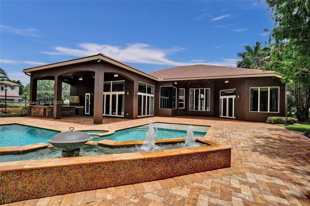 15093 SW 16th St, Davie, FL 33326 - view of pool featuring french doors, a patio, and a pool with connected hot tub