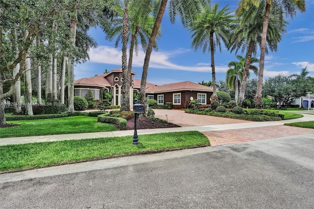 15093 SW 16th St, Davie, FL 33326 - view of front of home featuring decorative driveway, a front yard, and stucco siding
