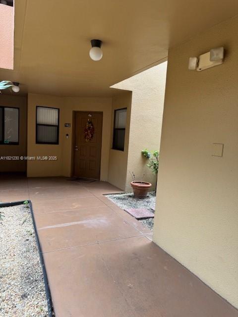 15495 N Miami Lakeway N Unit 102, Miami Lakes, FL 33014 - view of exterior entry featuring stucco siding
