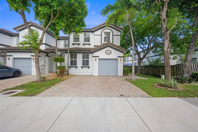 7633 NW 114th Path Unit 7633, Doral, FL 33178 - view of front of property with decorative driveway, stucco siding, a garage, and a tile roof