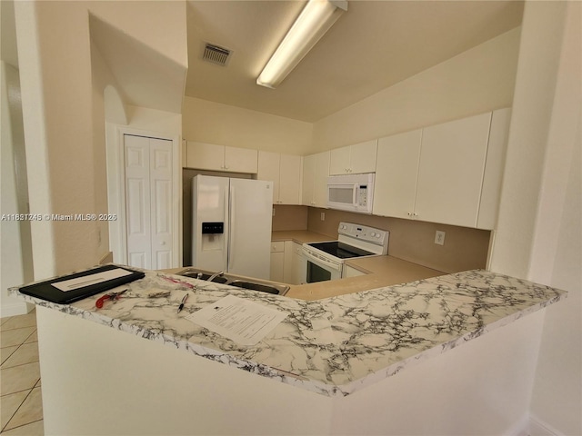 7633 NW 114th Path Unit 7633, Doral, FL 33178 - kitchen with white appliances, light tile patterned flooring, light countertops, and white cabinets