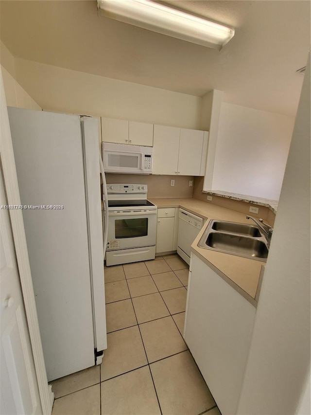 7633 NW 114th Path Unit 7633, Doral, FL 33178 - kitchen featuring white appliances, light tile patterned flooring, light countertops, and white cabinetry