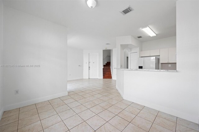 7633 NW 114th Path Unit 7633, Doral, FL 33178 - unfurnished living room featuring light tile patterned flooring and baseboards