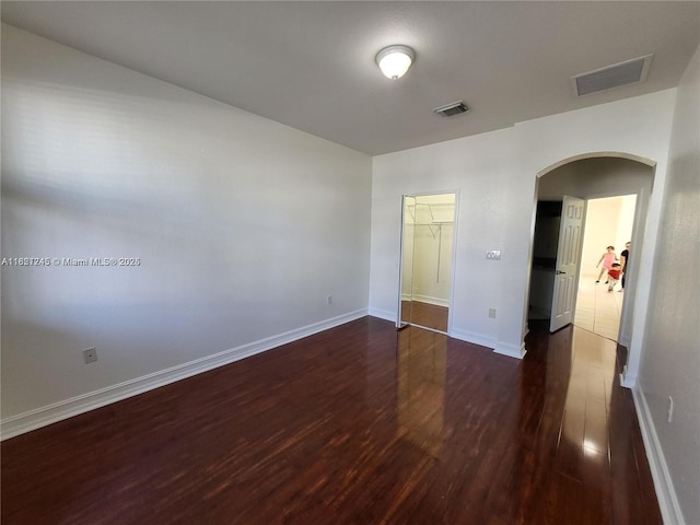7633 NW 114th Path Unit 7633, Doral, FL 33178 - empty room with dark wood-style flooring and arched walkways