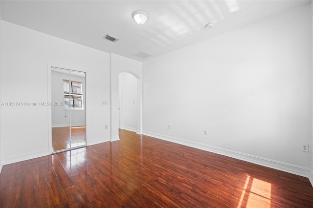 7633 NW 114th Path Unit 7633, Doral, FL 33178 - unfurnished bedroom featuring arched walkways and wood finished floors