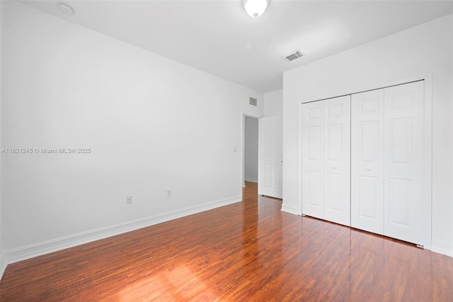 7633 NW 114th Path Unit 7633, Doral, FL 33178 - unfurnished bedroom featuring wood finished floors and a closet