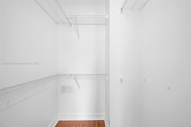 7633 NW 114th Path Unit 7633, Doral, FL 33178 - walk in closet featuring wood finished floors