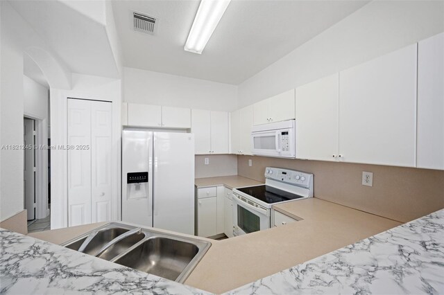 7633 NW 114th Path Unit 7633, Doral, FL 33178 - kitchen featuring white appliances, light countertops, and white cabinetry
