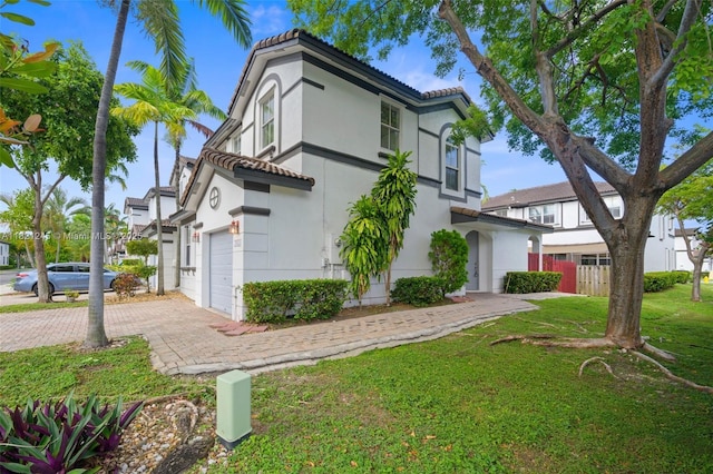 7633 NW 114th Path Unit 7633, Doral, FL 33178 - view of front of property featuring a tiled roof, a garage, stucco siding, and driveway