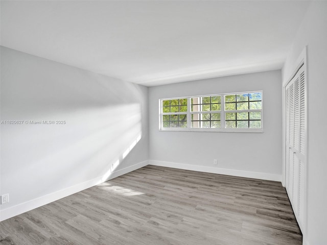 605 Oaks Dr Unit 309, Pompano Beach, FL 33069 - unfurnished bedroom featuring wood finished floors and a closet