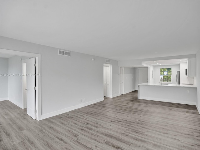 605 Oaks Dr Unit 309, Pompano Beach, FL 33069 - unfurnished living room featuring light wood-type flooring and recessed lighting