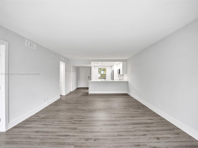 605 Oaks Dr Unit 309, Pompano Beach, FL 33069 - unfurnished living room featuring wood finished floors