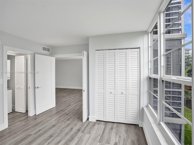 605 Oaks Dr Unit 309, Pompano Beach, FL 33069 - unfurnished bedroom with wood finished floors and a closet