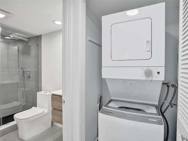 605 Oaks Dr Unit 309, Pompano Beach, FL 33069 - laundry area with stacked washing machine and dryer and recessed lighting