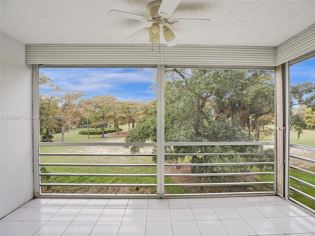 605 Oaks Dr Unit 309, Pompano Beach, FL 33069 - unfurnished sunroom with a ceiling fan and view of scattered trees