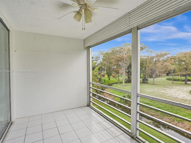 605 Oaks Dr Unit 309, Pompano Beach, FL 33069 - unfurnished sunroom featuring a ceiling fan and view of scattered trees