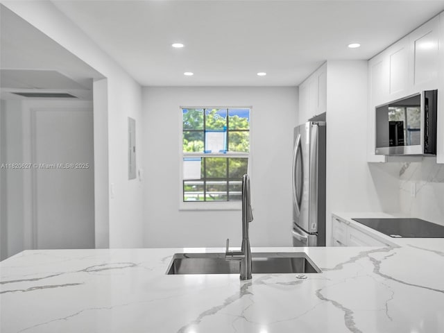 605 Oaks Dr Unit 309, Pompano Beach, FL 33069 - kitchen featuring stainless steel appliances, recessed lighting, white cabinets, and light stone countertops