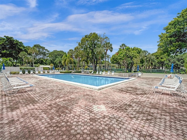 605 Oaks Dr Unit 309, Pompano Beach, FL 33069 - community pool with a patio area and view of scattered trees